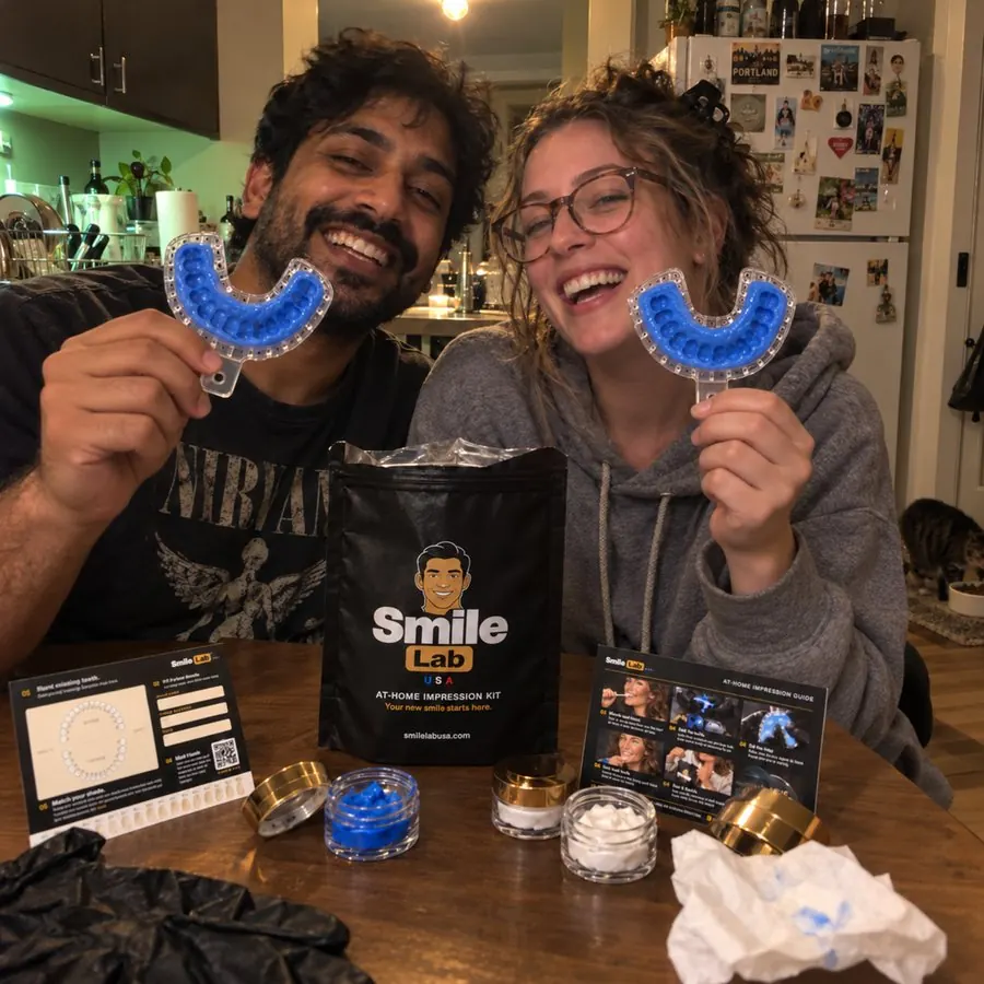 A couple holding Smile Lab impression trays at home