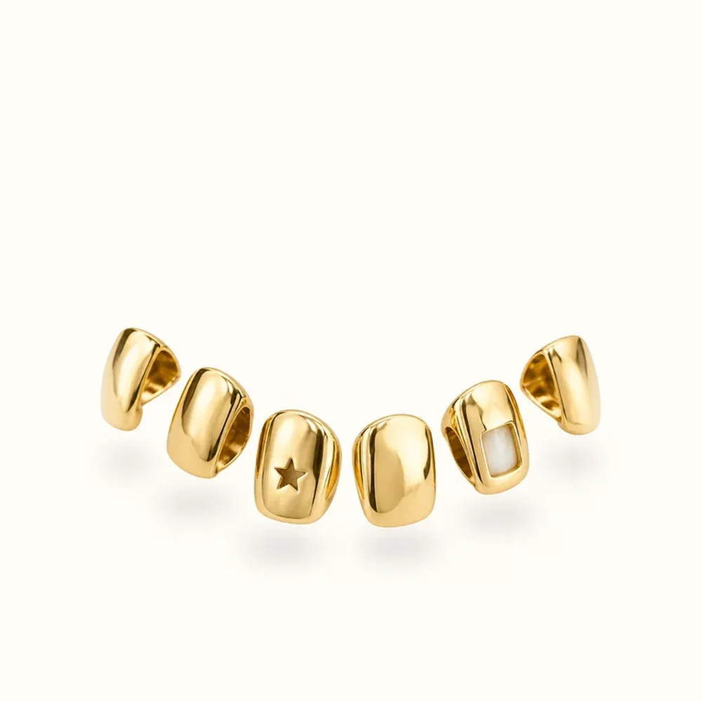 Gold Tooth caps — custom fitted alongside your other teeth, available with gemstones, red, clear, blue, dollar sign, martini glass, initial letter