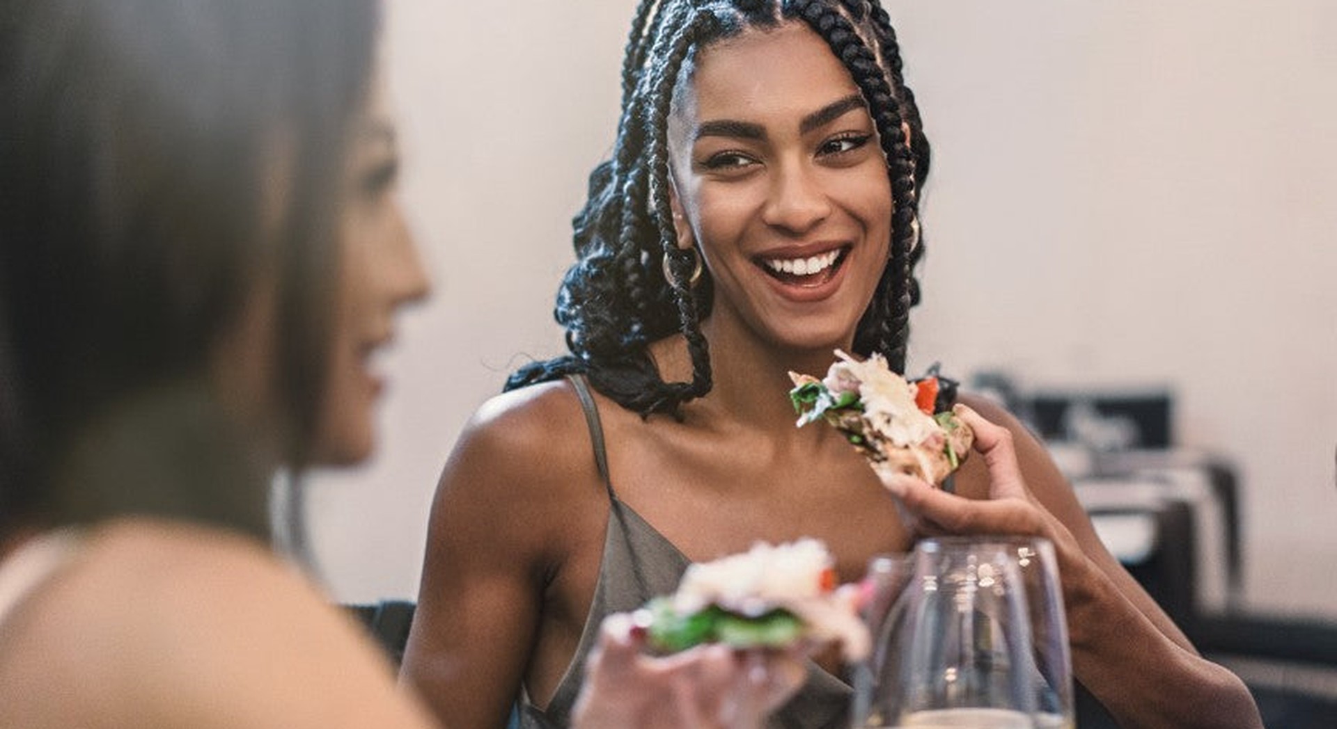 Friends laughing together over lunch